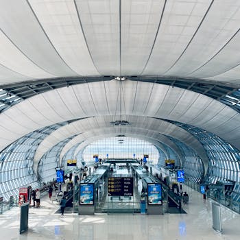 Aerial view of Suvarnabhumi Airport's futuristic terminal with modern design and spacious interior.